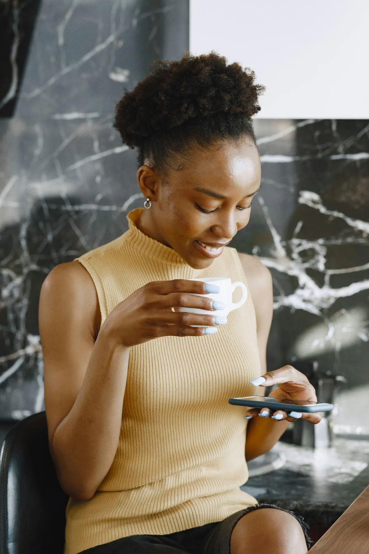 Person reading a message on their phone with a thoughtful expression, daily questions for couples