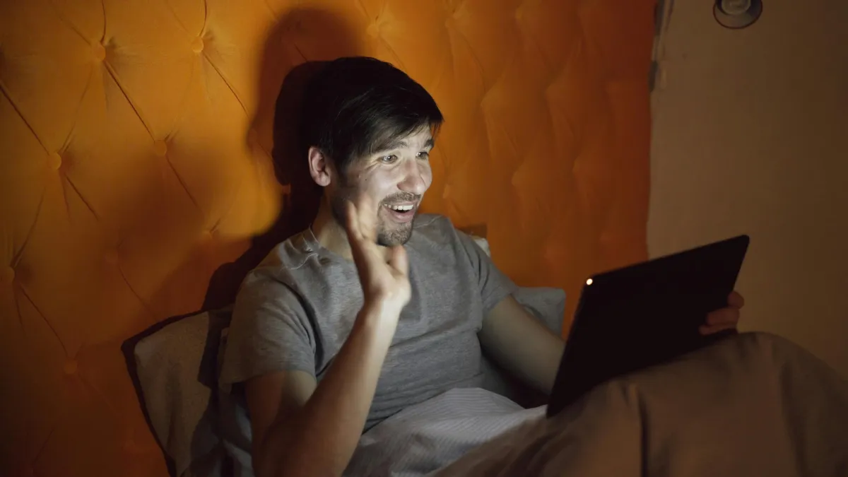 Two people on a video call, one gesturing while talking