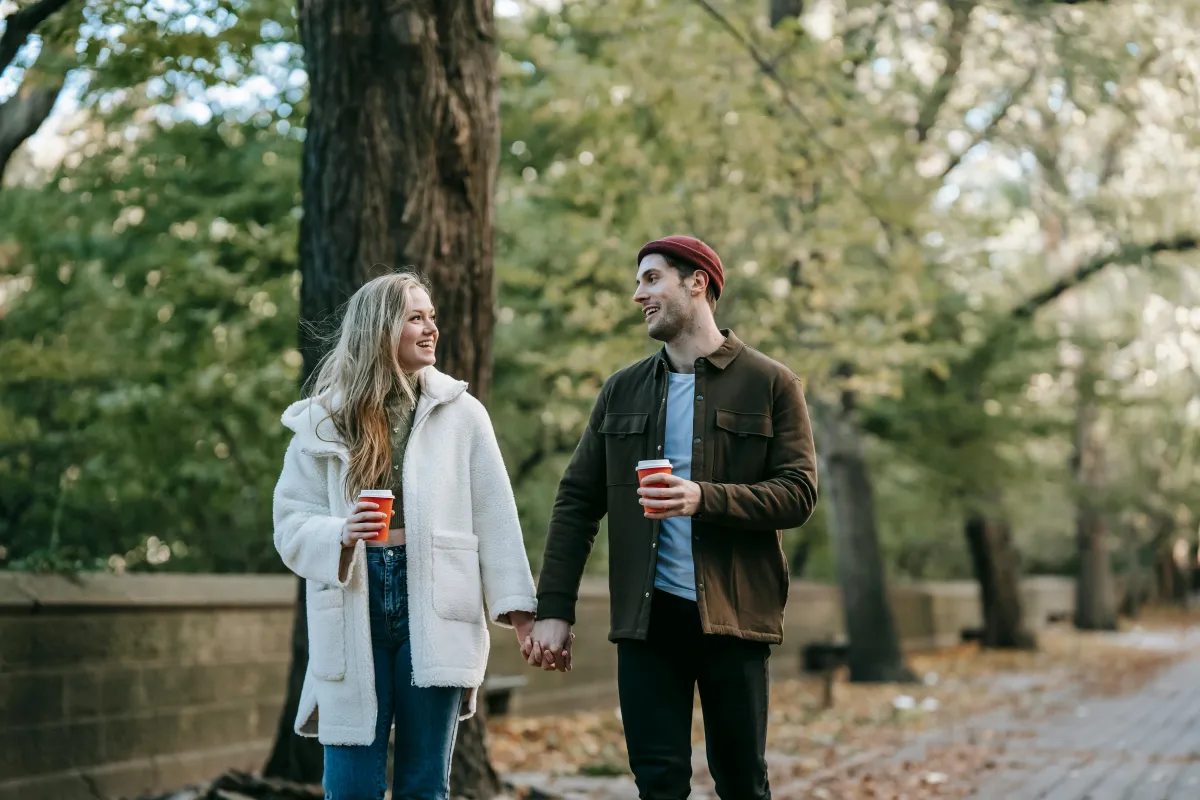Two people walking together outdoors looking relaxed and connected