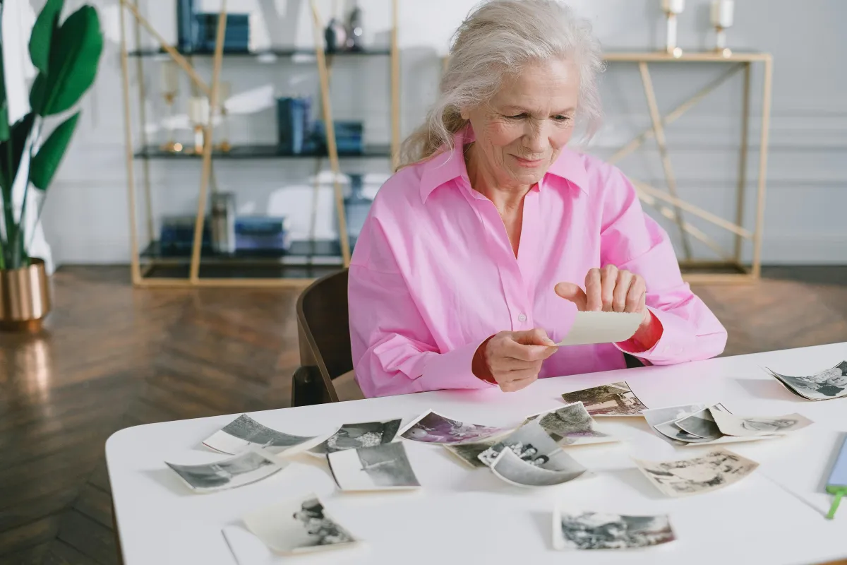 Expat looking at family photos, maintaining family connection across countries