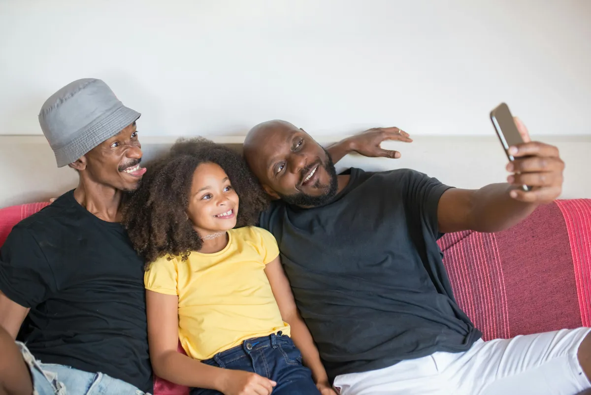Family looking at shared thoughts on phone for simple family connection