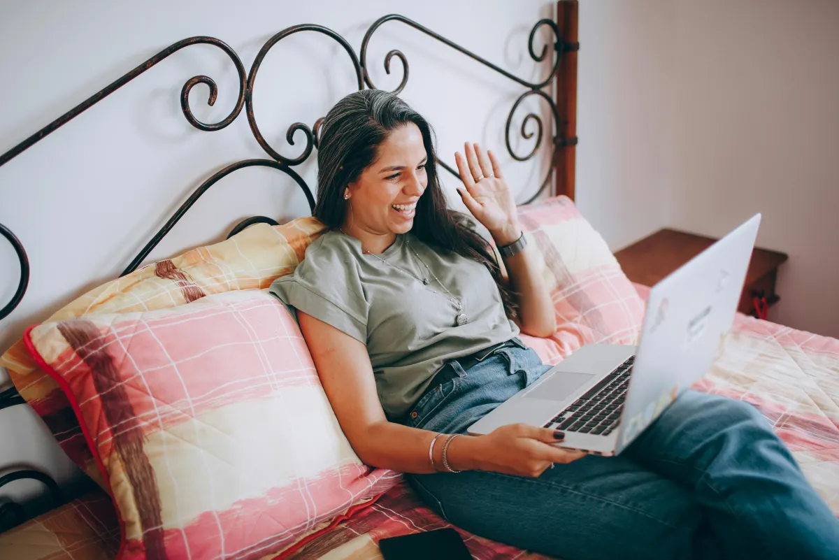 Couple smiling during a casual video call on a laptop