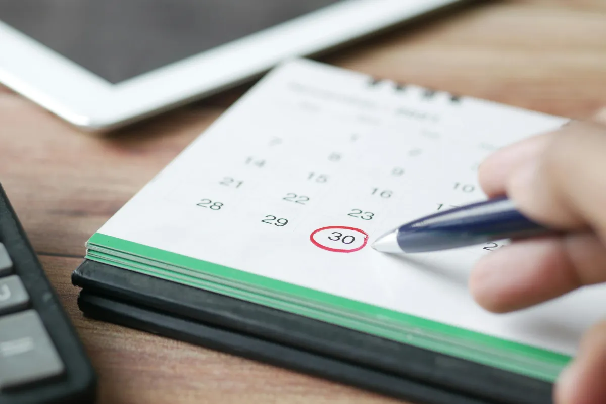 Calendar on a desk with a date circled in red