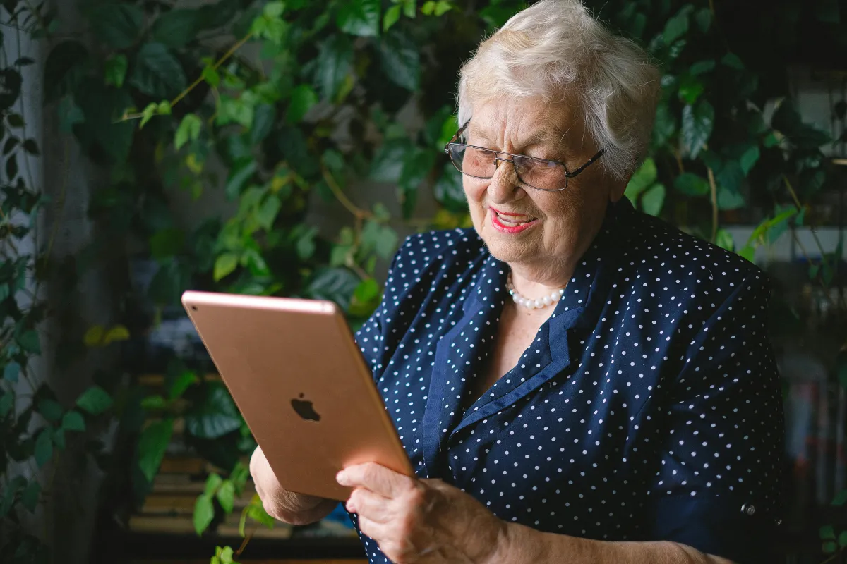 Aging parent reading a message from their adult child, staying close to family far away